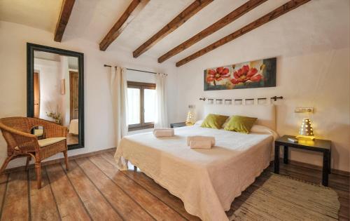 a bedroom with a bed and a table and a chair at Cadernera in Búger