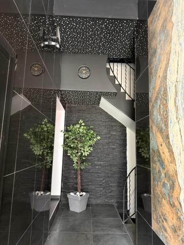 a hallway with two potted plants and a staircase at T2 modern in Frontenex-Villard-Rosset