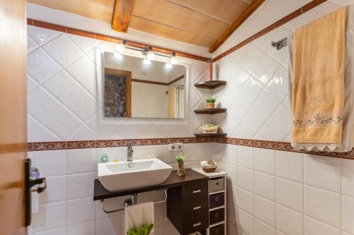 a bathroom with a sink and a mirror at Finca Can Jeroni in Felanitx