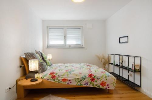 a bedroom with a bed and a window at Casa Ruf in Orsingen-Nenzingen