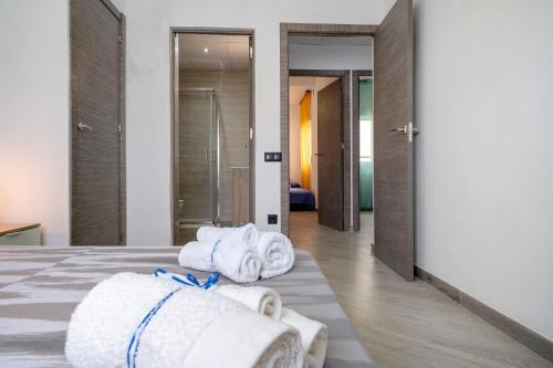 a pile of towels sitting on a bed in a room at Cambrils Turistic 3b in Cambrils