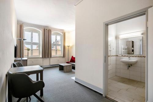 a bathroom with a sink and a toilet at Luckau Appartements 1695 in Luckau