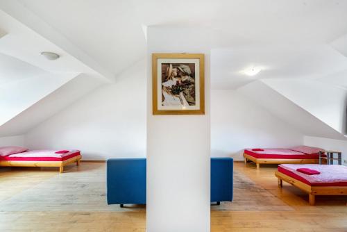 a room with three beds and a picture on the wall at Knödelhof in Putzbrunn