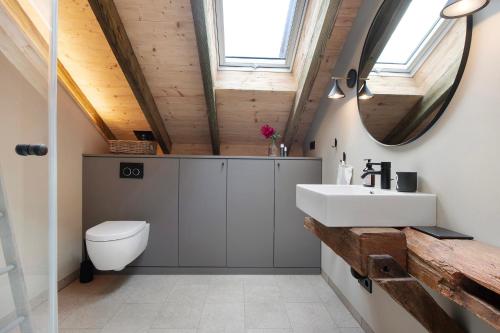 a bathroom with a white sink and a mirror at Ferienwohnung im Gehöft in Müllheim
