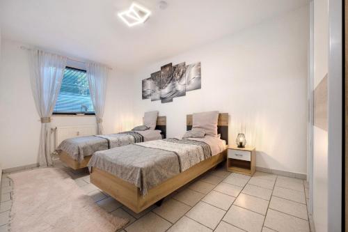 a bedroom with two beds and a window at Veith in Hildesheim