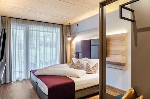 a bedroom with a bed with a large window at Apartment Steinbock in Pflach