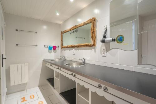a bathroom with a sink and a mirror at Villa Cap mer 17 in Saint-Palais-sur-Mer