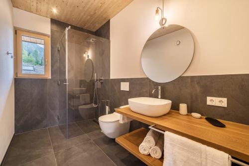 a bathroom with a sink and a shower at Naturapartments Alpreid Fichte in San Pancrazio dʼUltimo
