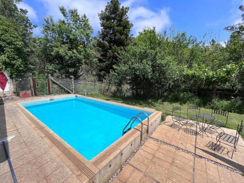 a large swimming pool in a yard at Quinta das Cavadas in Canedo