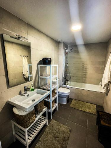 a bathroom with a sink and a tub and a toilet at Atico Bremadito in Torrox Costa
