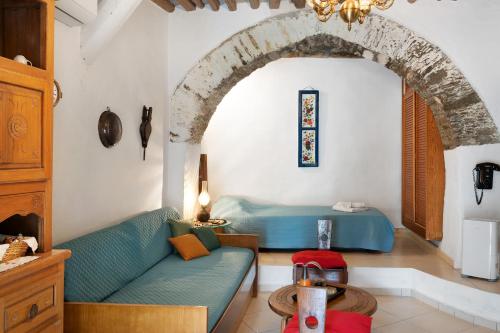 a living room with a couch and a bed at Maria in the castle Kea in Ioulis