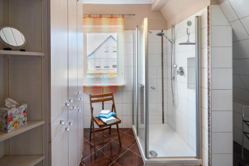 a bathroom with a shower with a glass door at Ferienwohnung Vierheller in Lauterbach