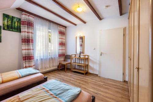 a room with a bed and a table and a window at Apartment Malsam in Bräunlingen