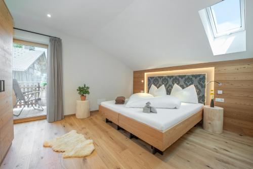a bedroom with a large bed and a large window at Furnerhof Apt Stearnzauber in Collepietra