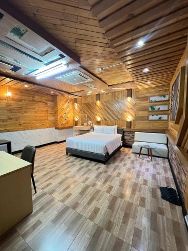 a large room with a bed and a desk at Hola Hotel in Can Tho