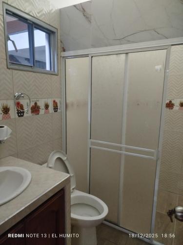 a bathroom with a shower with a toilet and a sink at Villa ceiba in Guaduas