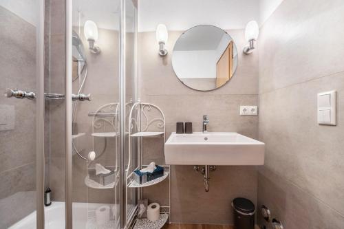 a bathroom with a sink and a shower at Haus Wacholder in Undeloh