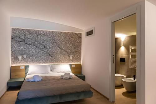 a bedroom with a bed with two towels on it at Luxury terrazza in Bari