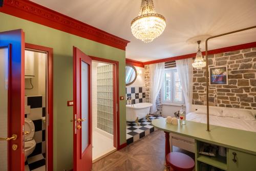 a bathroom with a tub and a sink and a bath tub at Casa Libertà Suites & Studios Piran in Piran