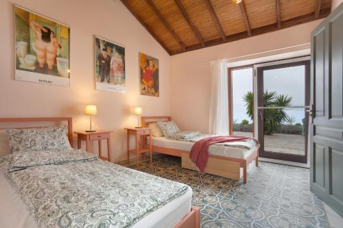 a bedroom with two beds and a window at Casa del Cielo in Adeje