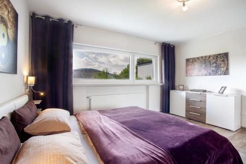 a bedroom with two beds and a window at Ferienwohnung Am Wald in Eslohe