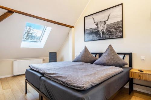 a bedroom with a bed with a picture of a bull on the wall at Pendler- und Ferienwohnung Bröke in Ahaus