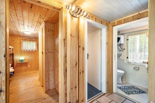 a wooden bathroom with a shower and a toilet at Bungalow 6 - Finnhütte in Niesky
