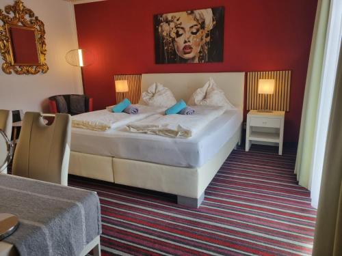 a bedroom with a large white bed in a room at Simply Rooms in Velden am Wörthersee
