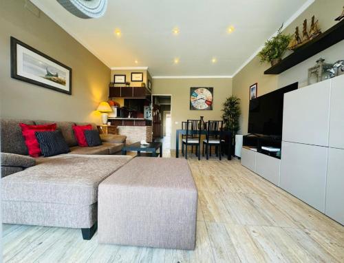 a living room with a large bed and a couch at Casa Azul Torreira in Torreira