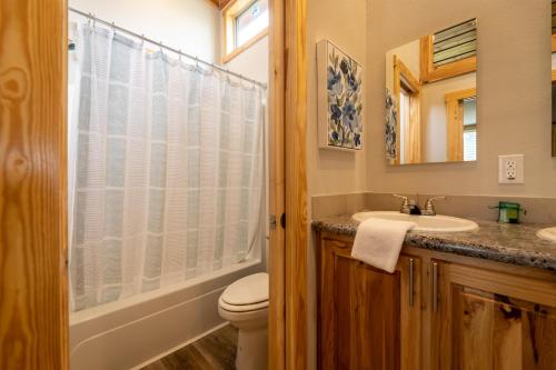a bathroom with a sink and a toilet and a mirror at Four Corners RV Resort in Antioch