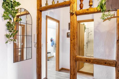 a room with a wooden door and a mirror at Ferienwohnung Thüringer Wald in Ilmenau