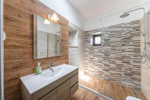 a bathroom with a sink and a shower at Old manor house in Syvota