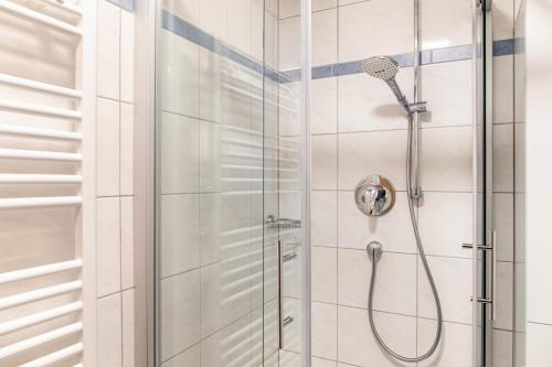 a shower with a shower head in a bathroom at Apart Elena in See