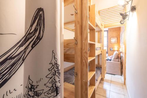 a tiny house with a staircase and a room at Les Narcisses in Morillon