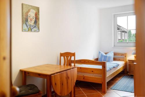 a small room with a bed and a table at Haus Seeadler Wohnung 10 in Koserow