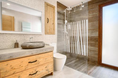 a bathroom with a sink and a shower at Casa Stone in Benissa