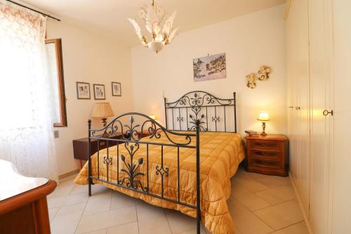 a bedroom with a bed and a chandelier at Casa Kefera a Otranto in Otranto