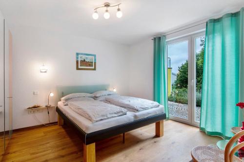 a bedroom with a bed and a large window at Ferienwohnung Milita in Lörrach