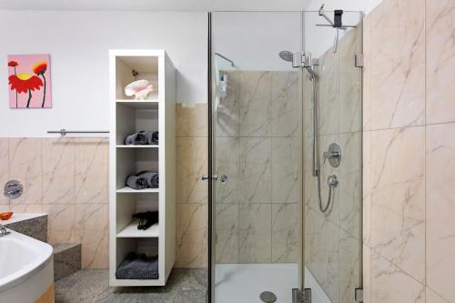 a shower with a glass door in a bathroom at Ferienwohnung Milita in Lörrach