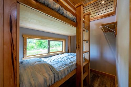 a bedroom with two bunk beds and a window at Four Corners RV Resort in Antioch