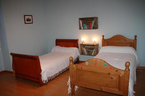 a bedroom with two beds and a mirror on the wall at Le Mas des Cigales in Avignon