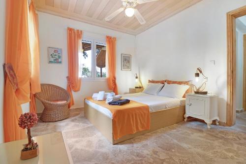 a bedroom with a bed and a chair in it at The Sea Martin in Nydri