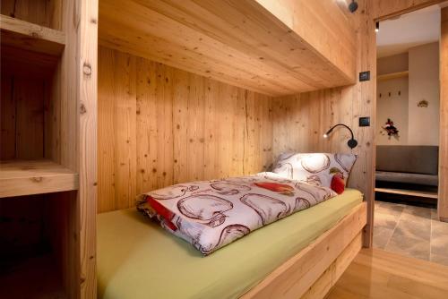 a sauna with a bed in a wooden wall at Apartment Silvy am Schlern in Völs am Schlern