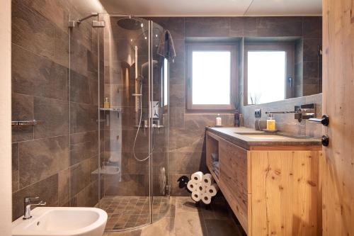 a bathroom with a shower and a sink and a toilet at Apartment Silvy am Schlern in Völs am Schlern