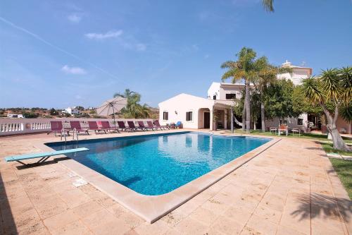 a swimming pool in front of a house at Quinta dos Fontanais in Tavira