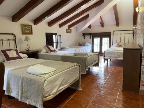a bedroom with three beds in a room at Casa de Antonio con piscina privada in Moratalla