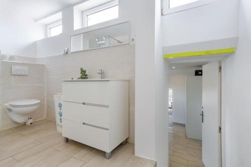 a bathroom with a sink and a toilet at Beach House el Poris 2 in Poris de Abona