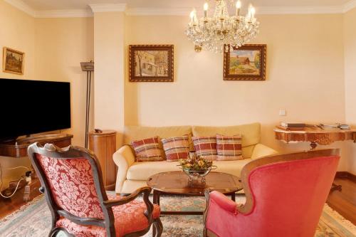 a living room with a couch and a table at Bela Sao Tiago 36 in Funchal