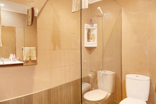 a bathroom with a toilet and a glass shower at Bela Sao Tiago 36 in Funchal