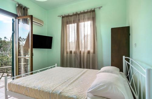 a hospital bed in a room with a window at Old Boat double studio 5 in Nikiana